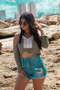 Young woman wearing sunglasses standing outdoors