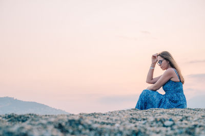 Rear view of woman standing against sky