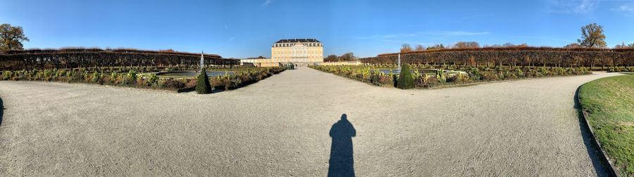 Rear view of man standing in front of historical building