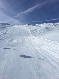 Scenic view of snow covered landscape against sky