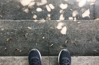 Low section of man standing on floor