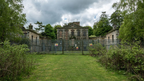 Historic building by trees against sky