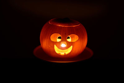 Close-up of illuminated pumpkin against black background
