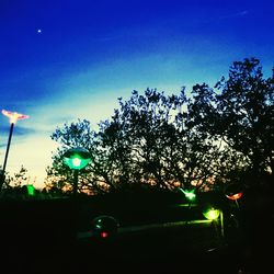 Low angle view of illuminated street light at night