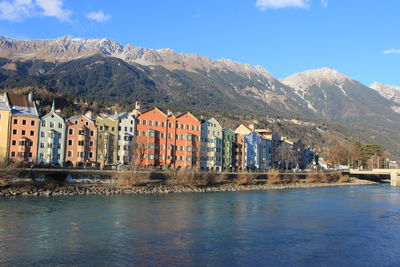 Panoramic view of city by mountains against sky