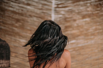 Rear view of woman standing against blurred background