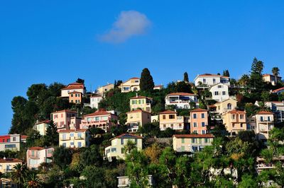 Buildings in city against blue sky