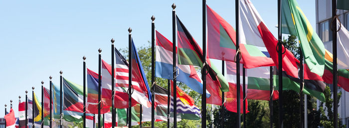 Low angle view of flags against clear sky