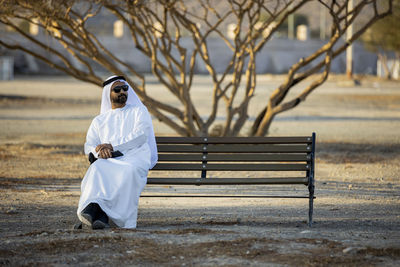 Woman sitting on bench at park