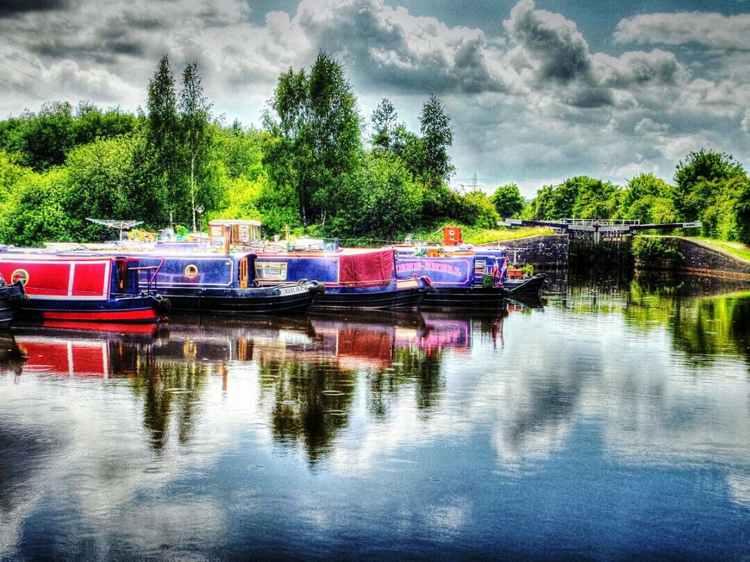 BOATS MOORED ON RIVER