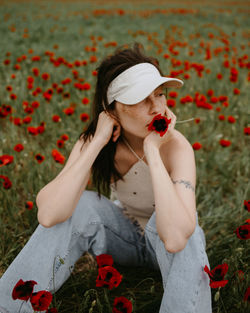 Woman looking away holding flower
