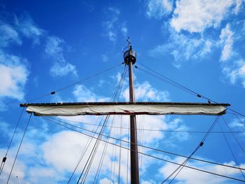 Low angle view of sailboat against blue sky