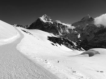 Scenic view of snow covered mountains against sky