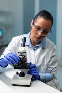 Female scientist working at table