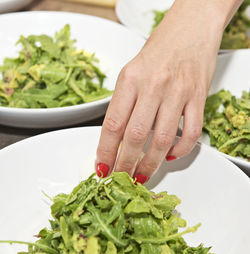 Midsection of man preparing food in plate