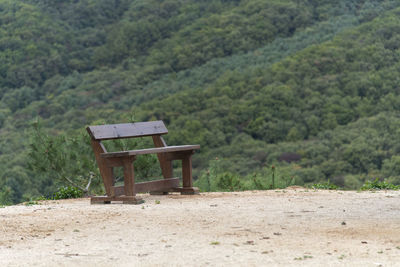 View of an empty bench on the hill