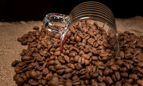 Close-up of coffee beans in glass on table