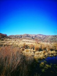 Landscape with mountain range against clear blue sky