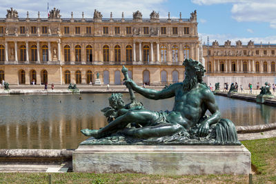 Versailles, france - august 20 2017 - statue at the parterre d'eau in the gardens of versailles.