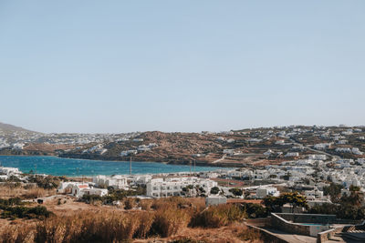 High angle view of townscape by sea against sky