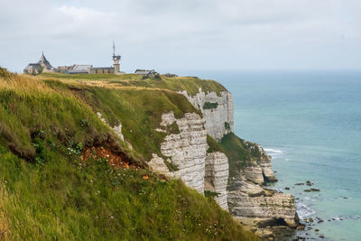 Scenic view of sea and buildings against sky