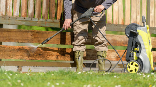 Low section of man working on wood