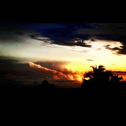 Silhouette of landscape against cloudy sky