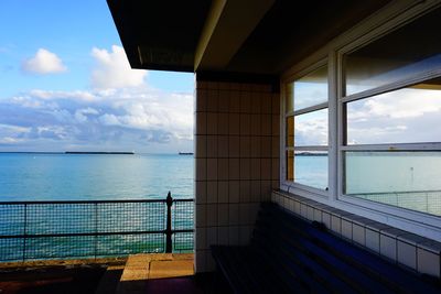 Pier over sea against blue sky