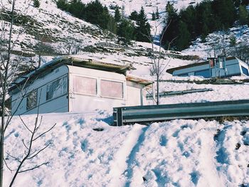 Low angle view of trailer home on snow covered mountain