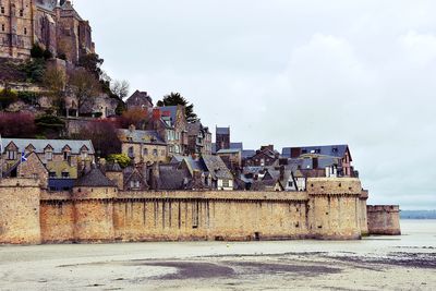 Houses in town against sky