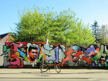 Graffiti on bicycle against sky