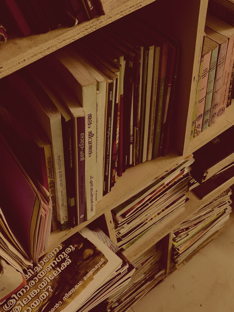 TILT IMAGE OF BOOKS IN BUILDING SEEN THROUGH OPEN