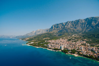 Scenic view of bay against clear blue sky