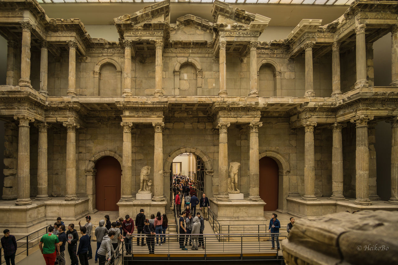 large group of people, tourism, travel destinations, architecture, architectural column, history, real people, lifestyles, tourist, built structure, city, city life, arch, men, women, indoors, vacations, people, day, visiting, adults only