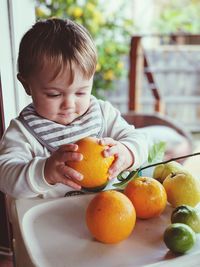 High angle view of boy holding fruits