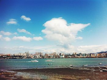 View of cityscape against cloudy sky