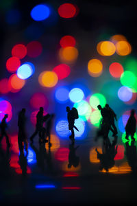 Defocused image of people enjoying at night