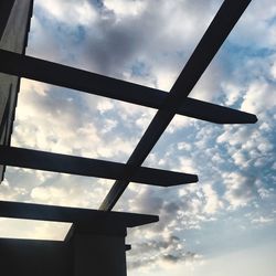 Low angle view of silhouette cross against sky