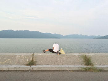 Man sitting on seashore