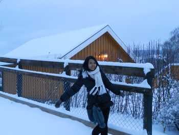 Woman standing on snow covered land