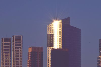 Sunlight reflecting on buildings against sky