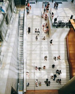 High angle view of people walking on escalator