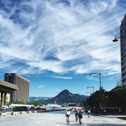 City street against cloudy sky