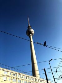 Low angle view of fernsehturm against clear sky in city