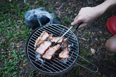 High angle view of man cooking on barbecue grill