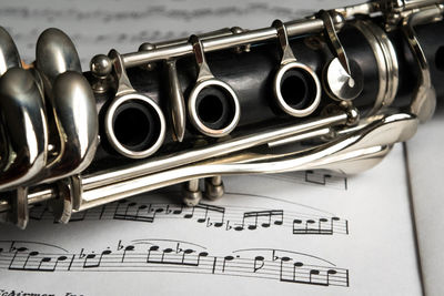 Close-up of clarinet on sheet music