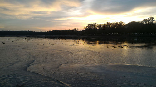 Scenic view of lake against sky during sunset