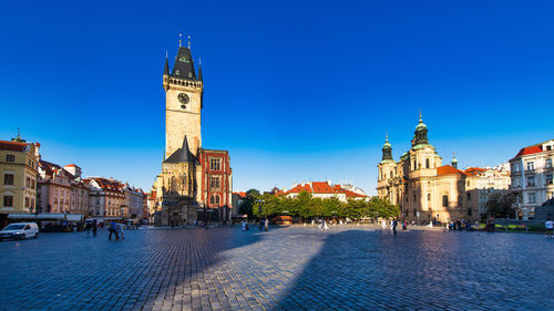 Buildings in city against blue sky