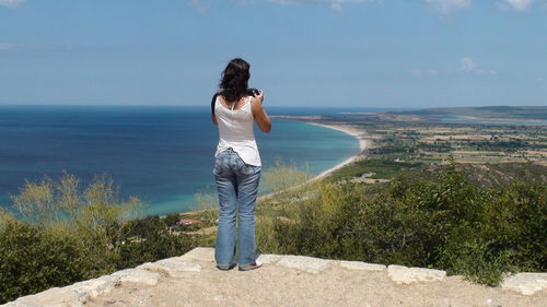 Rear view of woman standing on beach