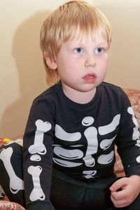 Portrait of cute boy looking away at home